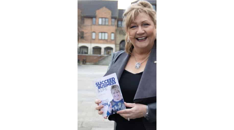 Bernie Allen holding her book - How to Build Self-Confidence