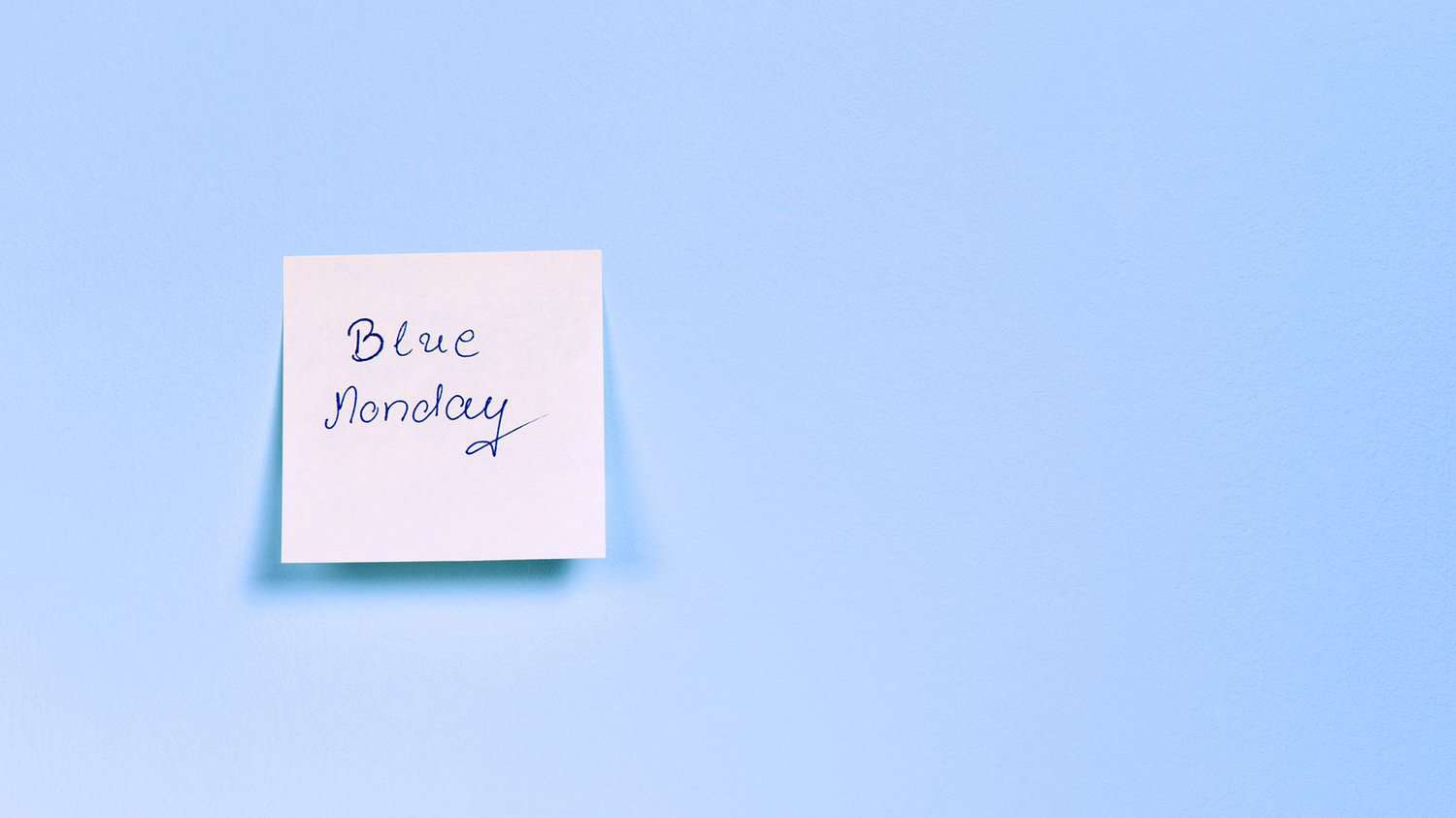 blue background, white sticky note with 'Blue Monday' written on it