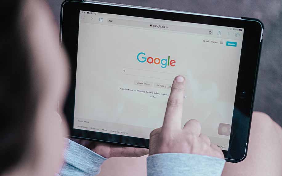 someone using google on a tablet to access serps SEO basics