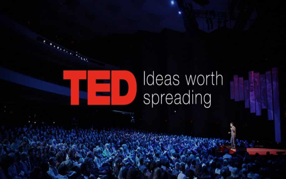 A photo of a man giving a TED Talk to a large audience. The words TED: Ideas worth spreading are written over top of the image