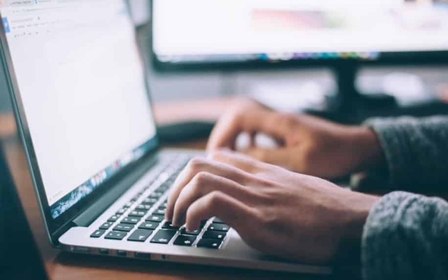 person typing on a laptop