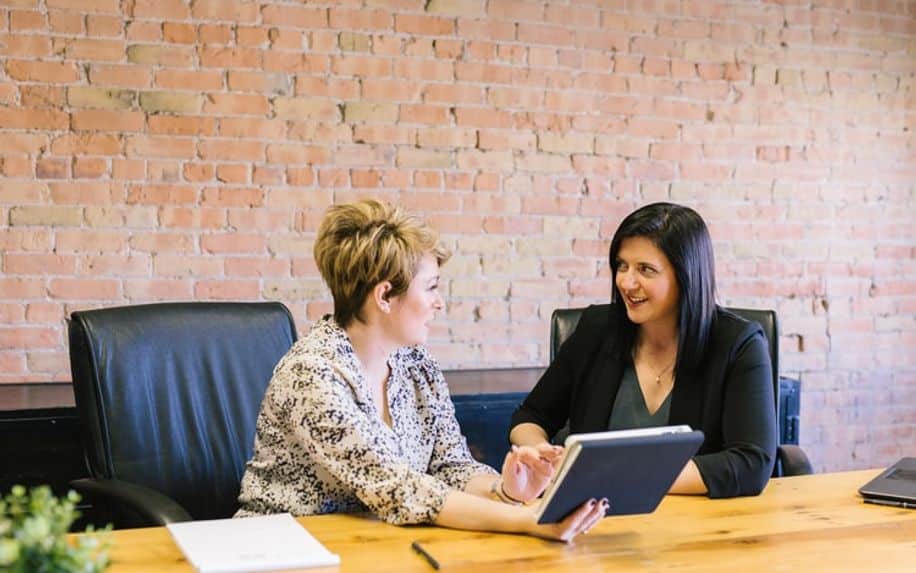 Word of mouth in action between two women