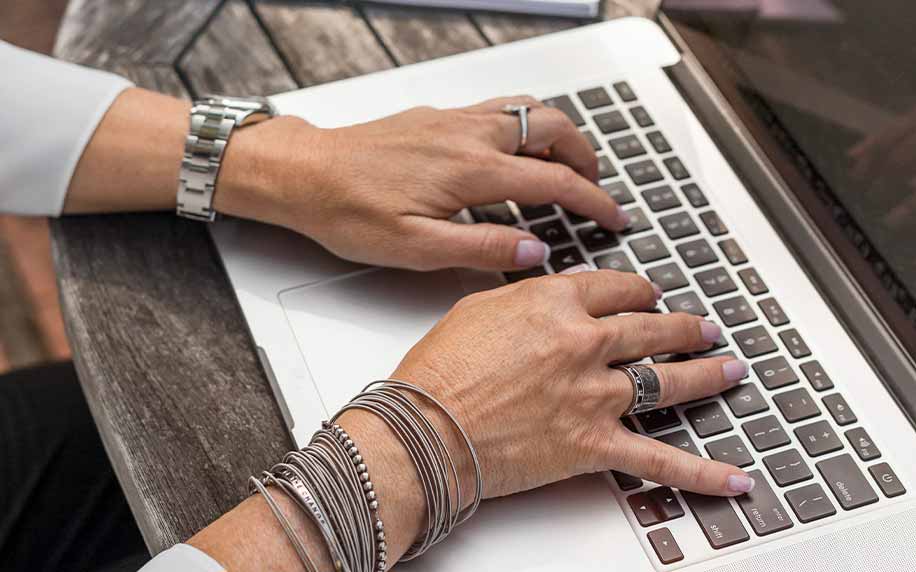 person typing their introduction onto a laptop