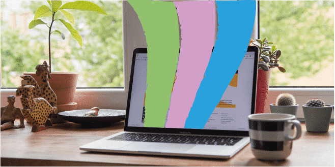 Laptop sitting on desk with colourful waves (green, pink, blue) coming out of laptop screen