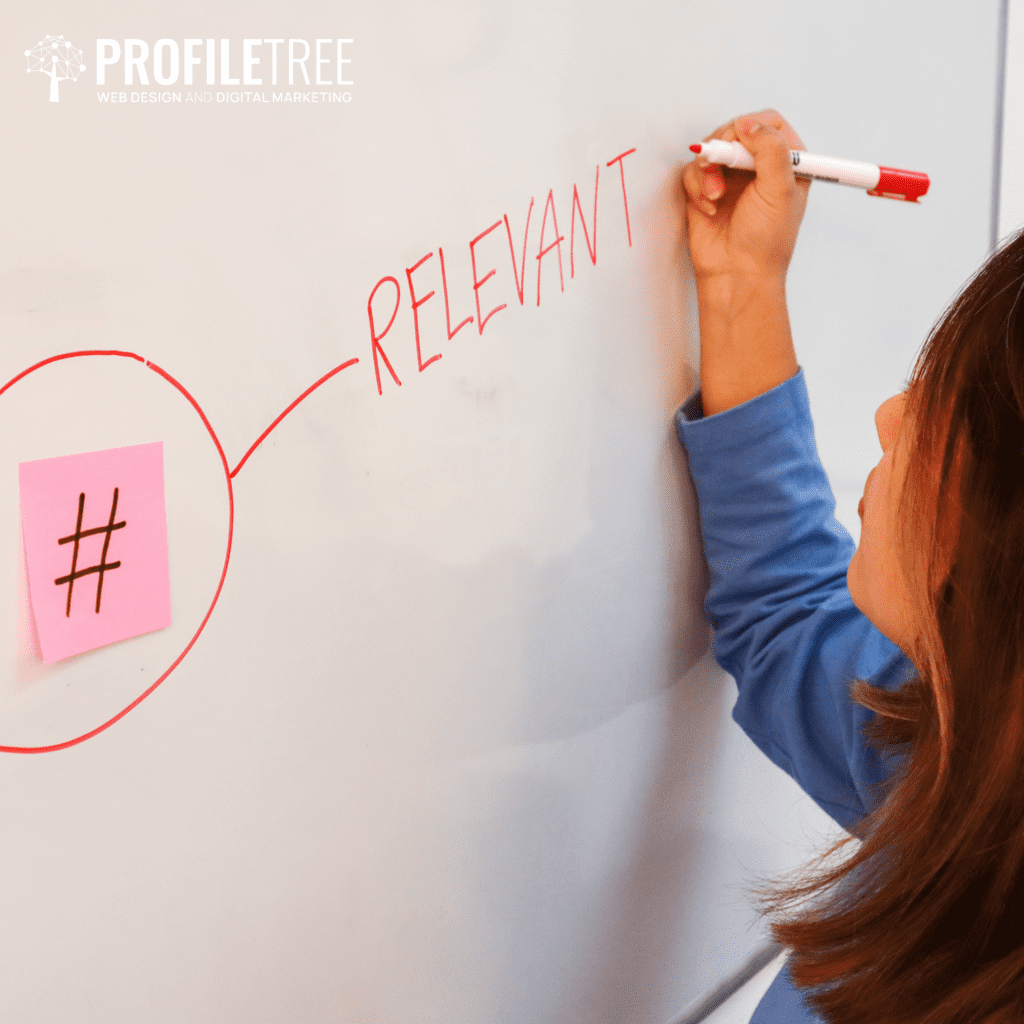 Image of someone writing on a whiteboard with a hashtag and the word relevant - creating a hashtag strategy